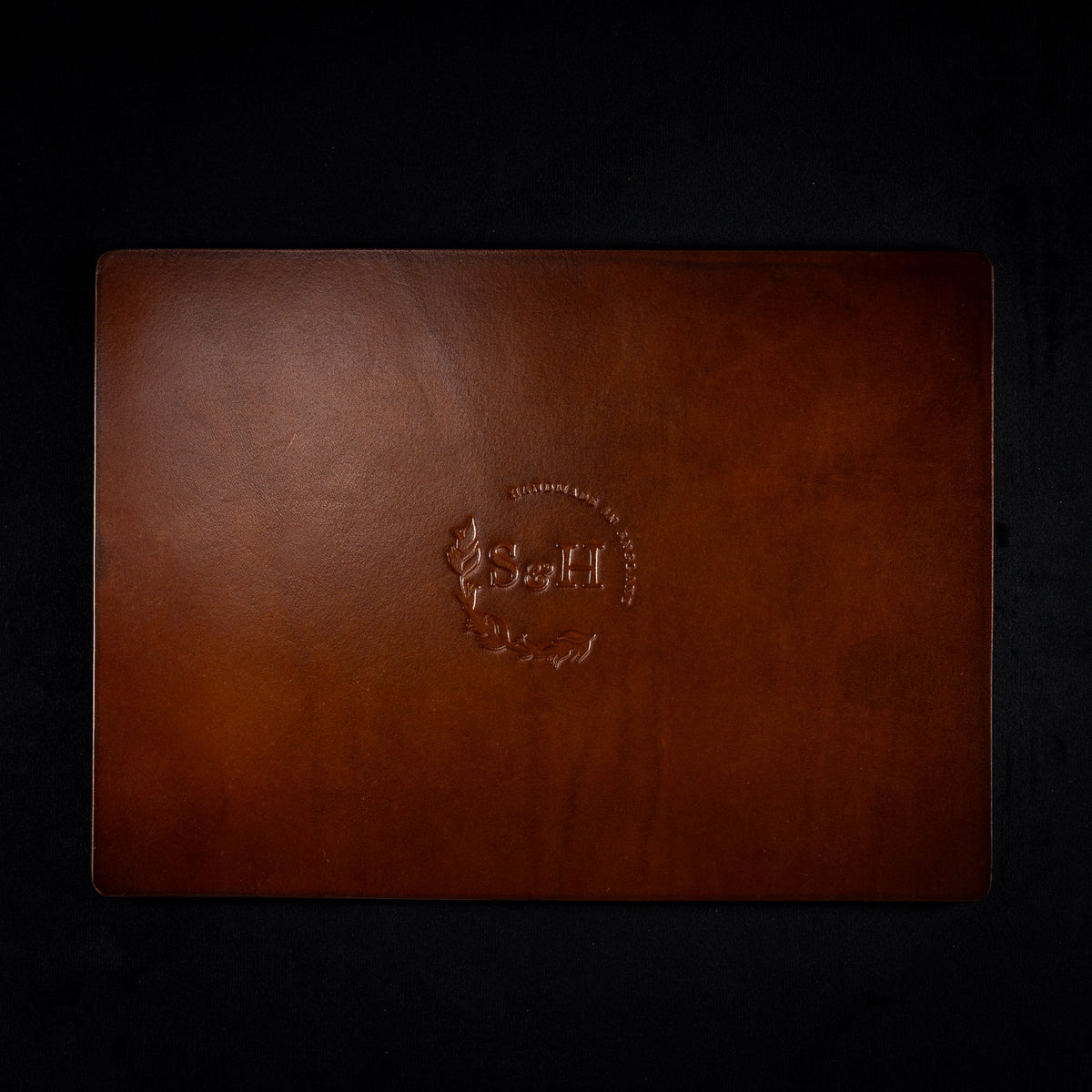 Back of The Astro leather tarot mat in plain brown leather with the Sigil and Hide logo at the centre