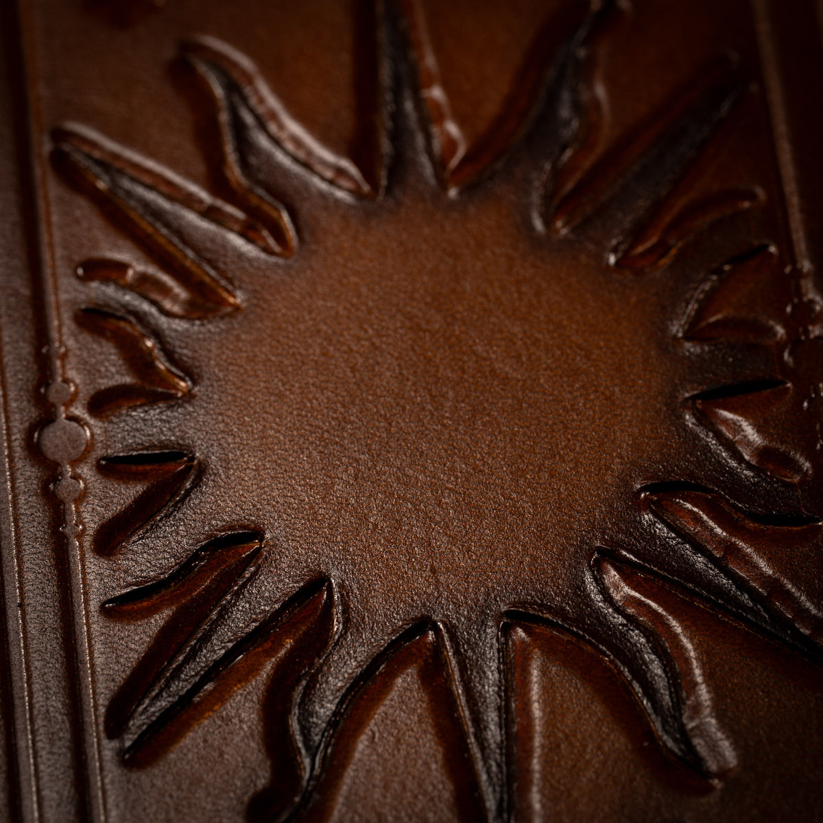 Close view of the sun and its rays on The Astro leather tarot mat