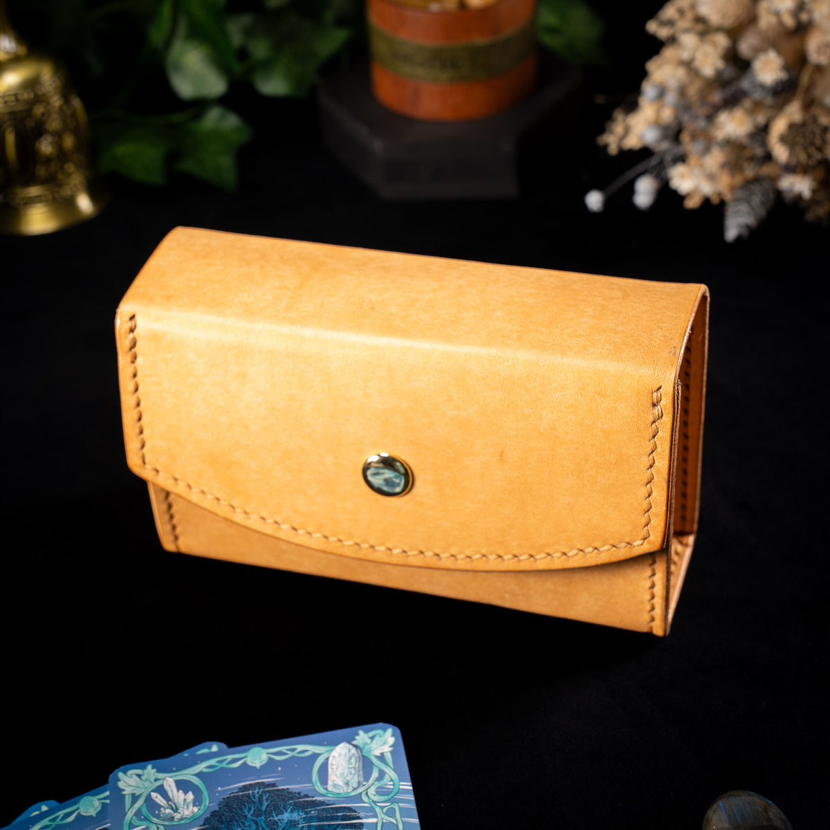 The Oracle deck case in natural Bone leather, the Air colourway, closed with tan stitching and a brass stud