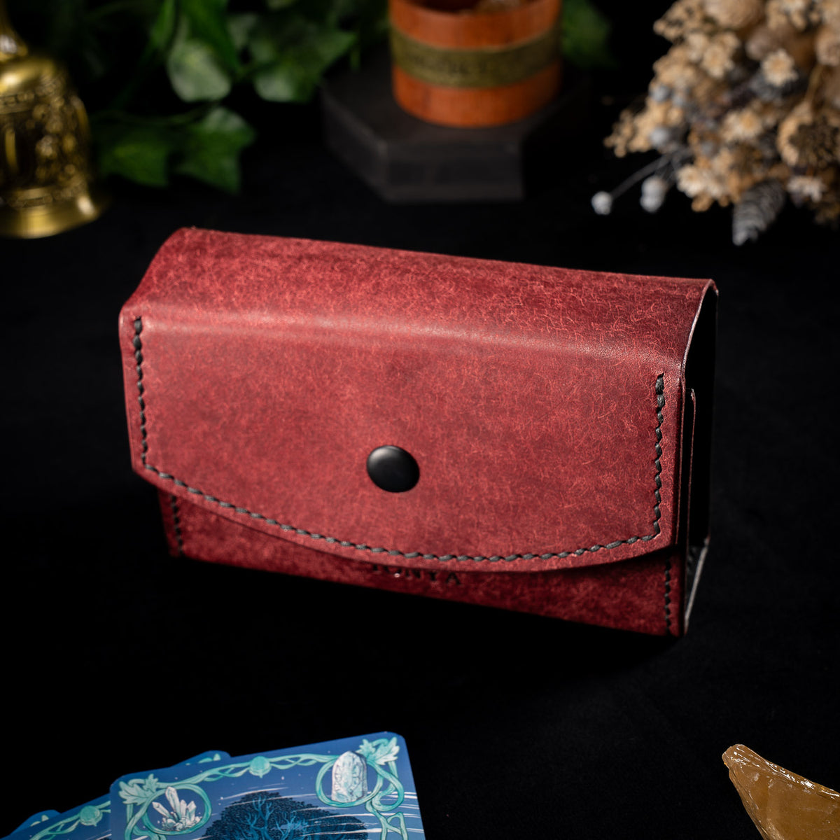 The Oracle deck case in deep red Mosto leather, the Fire colourway, closed with black stitching and a matte black stud