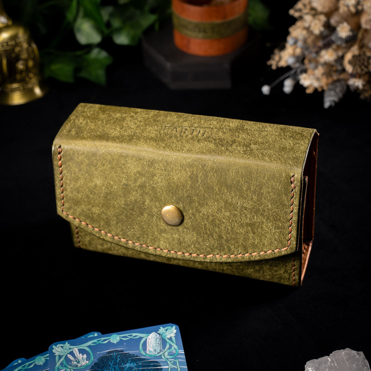 The Oracle deck case in olive leather, the Earth colourway, with EARTH embossed on the lid and cognac lining just visible at the side